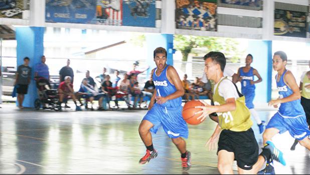 Marist Crusaders with a fast break, while Samoana Sharks try to chase them down, last Saturday morning at the Samoana High School Gymnasium in Utulei.  [photo: Ese Malala]