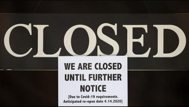 In this April 2, 2020 file photo, a notice of closure is posted at The Great Frame Up in Grosse Pointe Woods, Mich. The government is closing in on the $349 billion lending limit on its Paycheck Protection Program that is sending relief money to the nation’s small businesses. The Small Business Administration says that it has approved more than 1.6 million loans worth more than $339 billion. The program will likely reach its ceiling Thursday, April 16. (AP Photo/Paul Sancya, File) a notice of closure is posted at The Great Frame Up in Grosse Pointe Woods, Mich.