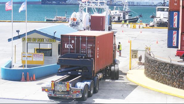 At 2:30p.m last Friday a container truck [top of photo] went through the container scanner equipment, while another container truck [bottom of photo] waited at the entrance to the Port of Pago Pago for its turn to go through the scanner located at the main dock.  [photo: FS]