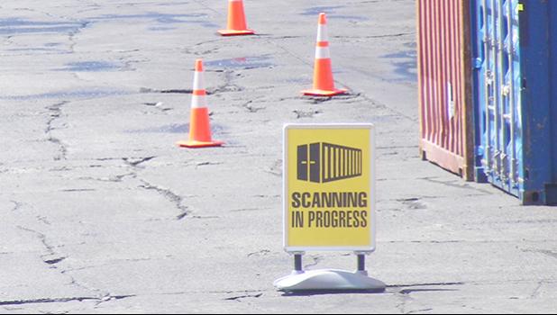 This Customs Division “SCANNING IN PROGRESS” sign was seen placed by a Customs agent just off the entrance to the Port of Pago Pago, before two container hauling trucks entered the main dock and went through the container scanner equipment around 2:30 p.m last Friday.  [photo: FS]