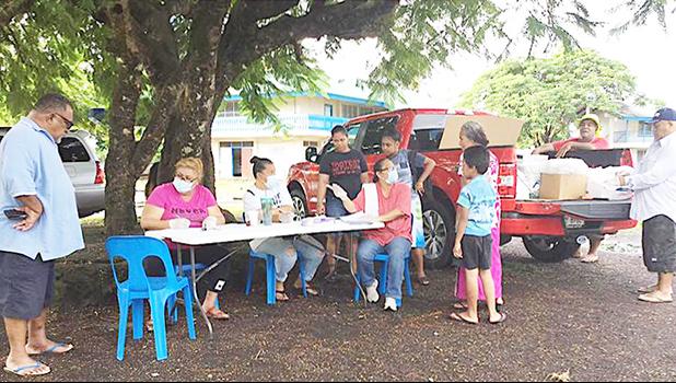 A Crew from the School Lunch Program, sitting at the table yesterday morning at Manulele Tausala Elementary School compound