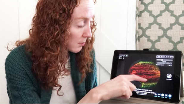 Woman using tablet to access NOAA education website