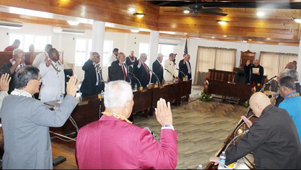 Senators raise their hands during the swearing-in ceremony