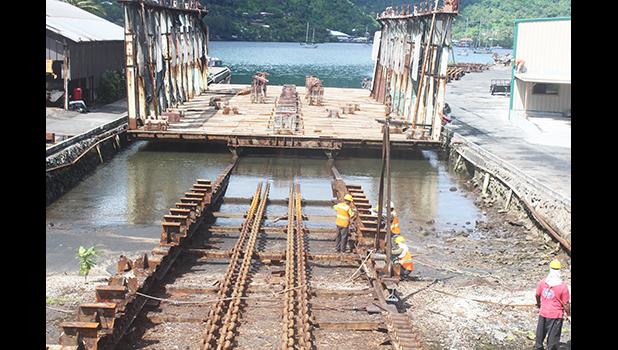 Ronald Reagan Shipyard employees working on repairs to the front portion of the 3,000-ton slipway at Satala yesterday morning. 