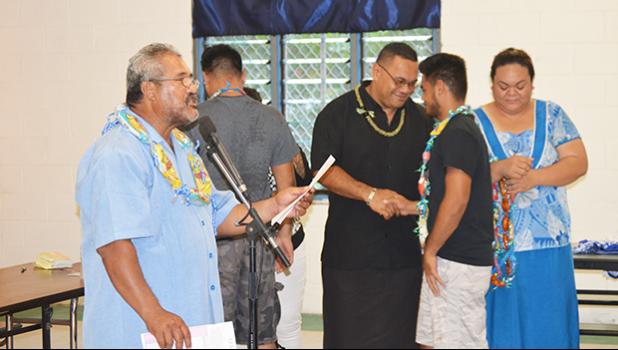 A senior player of the Samoana High School football team shaking hands with the team’s head coach Pati Pati Jr last Friday when the Booster Club donated the new uniform to the school football team. [photo AF]