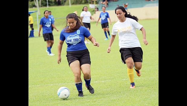 Samoana Sharks’ Deidra Steffany (left) defends against Fa’asao-Marist Cougars’ Lourdes Afoa