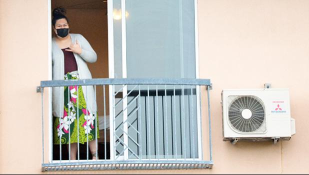 A passenger on the first repatriation flight on hotel balcony
