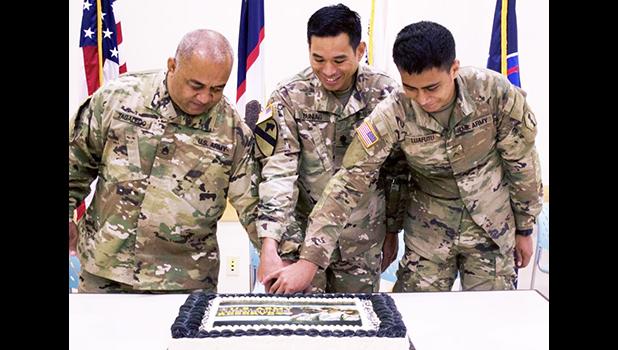 Staff Sgt. Faiupu Tagaleoo, assigned to Theater Support Group American Samoa Detachment, 9th Mission Support Command (left), representing the oldest unit member, and Pvt. Vend Luafutu, assigned to Charlie Company, 100th Battalion, 442nd Infantry Regiment, 9th Mission Support Command (right), along with Lt. Col. Alejandro Buniag, Commander, Theater Support Group American Samoa Detachment