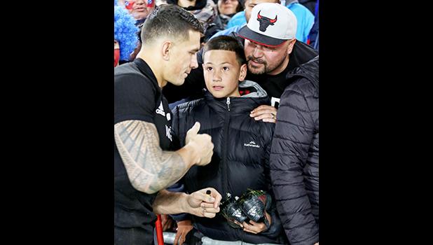 Sonny Bill Williams amazed Mason Smales with a gift of his red striped Adidas game shoes.   Mason is a cousin of the late beloved Peter Fatialofa.  The New Zealand All Blacks defeated Manu Samoa 15s 78-0 at Eden Park, Auckland, New Zealand.   [Photo: Barry Markowitz]