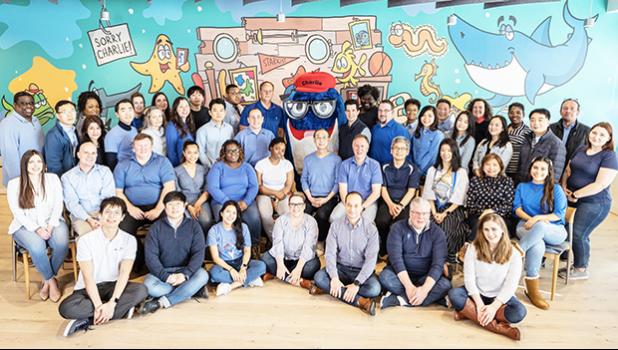 Some of StarKist’s staff in front of the Joe Wos mural