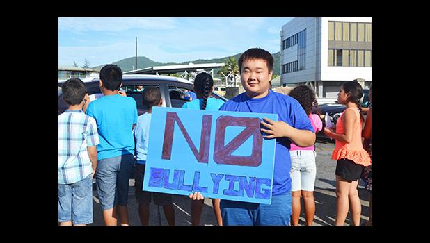 Posing for the Samoa News camera, one of the many South Pacific Academy students who participated in the school’s wave yesterday morning, reminding the public of the negative impact of bullying. [Photo: JL] 