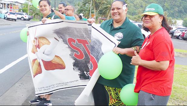 Women at a stop smoking wave with sign