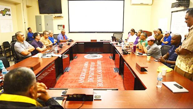 US Coast Cmdr. Ulysses Mullins, deputy sector commander, Coast Guard Sector Honolulu, along with Lt. Gov. Lemanu Peleti Mauga, and various officials, sing a prayer before conducting a post-storm briefing for Tropical Storm Gita at the Emergency Operations Center in American Samoa, Feb. 11, 2018. Coast Guard officials discussed the reopening of the Port of Pago Pago along with the response efforts for the grounding of the 88-foot commercial fishing vessel Chui Zai Fa No. 1 grounded about 300-yards off Leone 