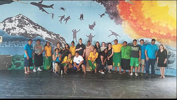 Students from Wahtonka Community School pose in front of a 38-foot-by-13-foot mural they painted in an open-air high school cafeteria in American Samoa. [courtesy photo]
