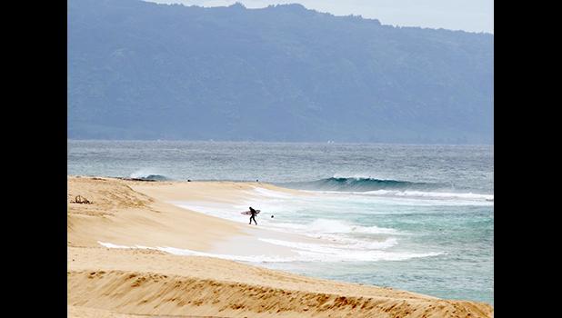 A surfer at Haleiwa HA