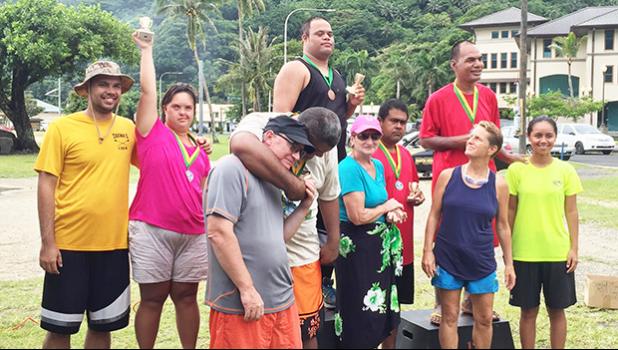 Sandy Scanlan coordinator of the PCSN with some of the athletes with special needs together with their families and friends who received gold medals during the Awards Ceremony of the first adaptive aquatic Swim Meet for special needs athletes in Amerika Samoa last Saturday at Utulei Beach. [Photo: Ese Malala]
