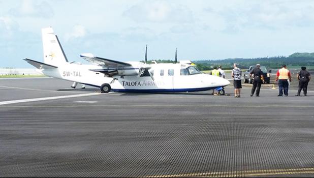 This Jan. 11, 2018 photo, circulated on social media, shows the Talofa Airways plane on its belly on the taxi-way at the main terminal at Pago Pago International Airport.  [Facebook photo]