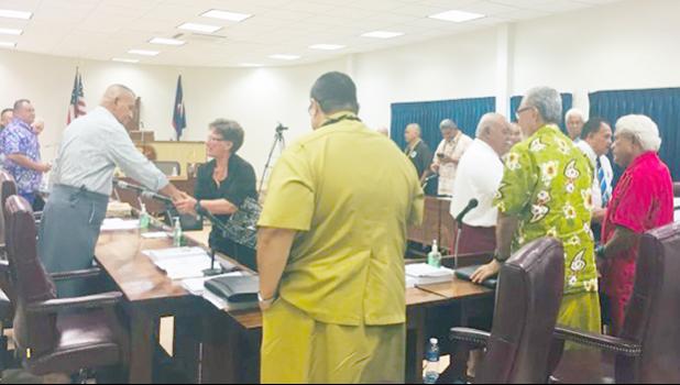 Territorial Administration on Aging Director Evelyn Lili’o Satele shaking hands with lawmakers