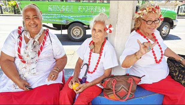 Three senior citizens at bus stop