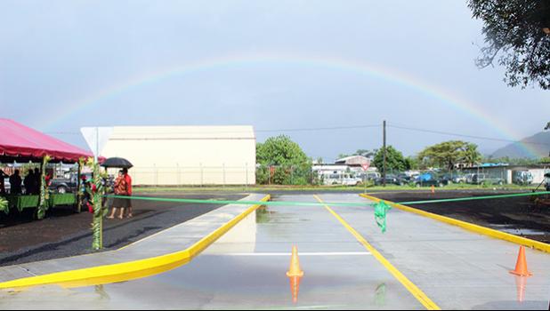 Rainbow over the Tasi Street Extension dedication ribbon