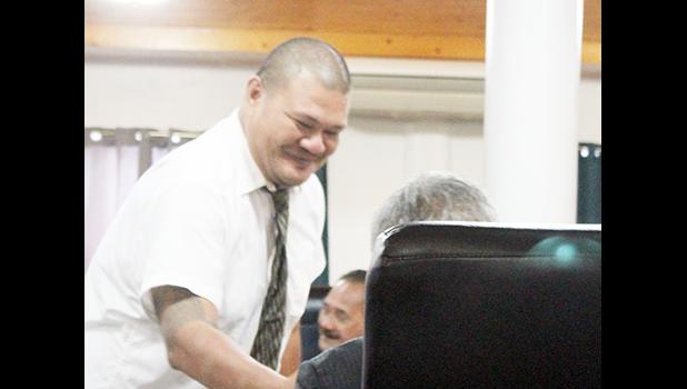 ASG Tax Office Manager Vaaimamao E. Poufa shaking hands with a Senator