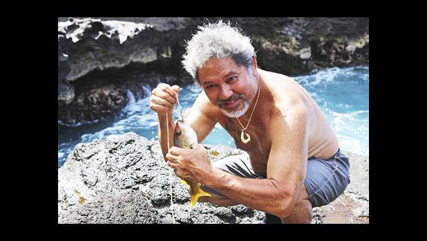 In this July 4, 2015, file photo provided by the Office of Hawaiian Affairs, G. Umi Kai uses a traditional Hawaiian hook to catch a fish at the Papahanaumokuakea Marine National Monument in Hawaii. Kai supports a plan to expand the monument. The White House says that President Barack Obama will expand the national monument off the coast of Hawaii, creating the world's largest marine protected area.  [Keola Lindsey/Office of Hawaiian Affairs via AP]