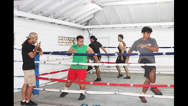 Boxers in a training session in the ring