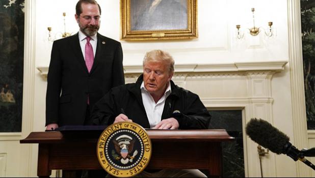 President Donald Trump signs an $8.3 billion bill to fight the coronavirus