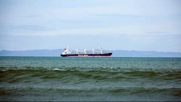 A transshipment vessel off shore of a Pacific island