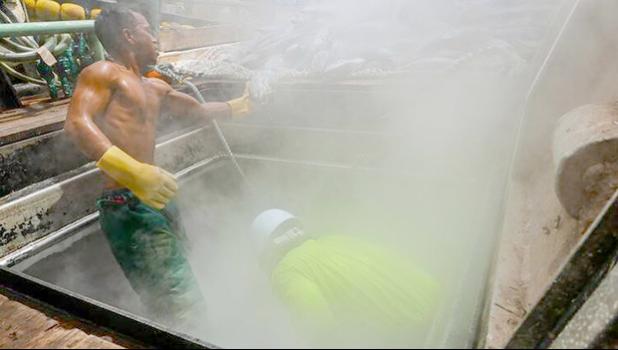 Fishermen working on a purse seiner in the Marshall Islands. Photo: Francisco Blaha Two tuna fishermen working on deck