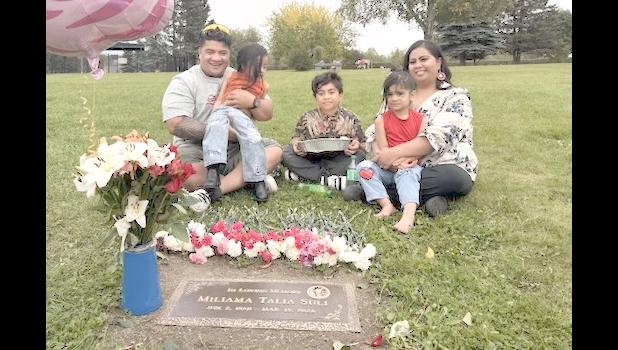 Michael Pese (left) and Tupe Smith (right) with their three children