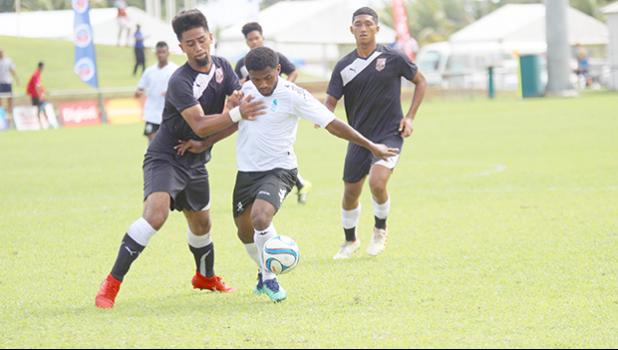 Ueli Tualaulelei (left) of American Samoa defends