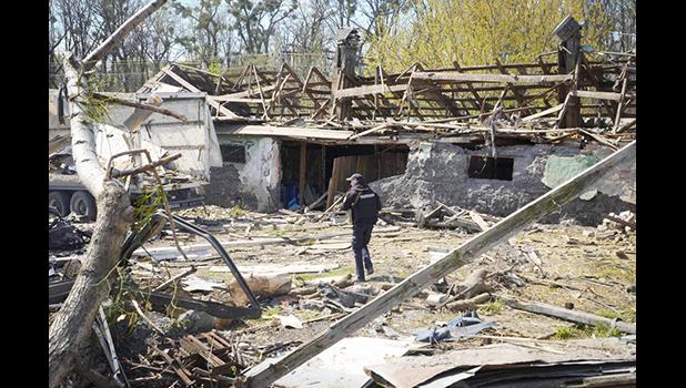 A police officer inspects a destroyed area following a Russian missiles attack on Thursday in Fastov, south of Kyiv, Ukraine, Friday, April 29, 2022. (AP Photo/Efrem Lukatsky) A destroyed area in Kyiv, Ukraine
