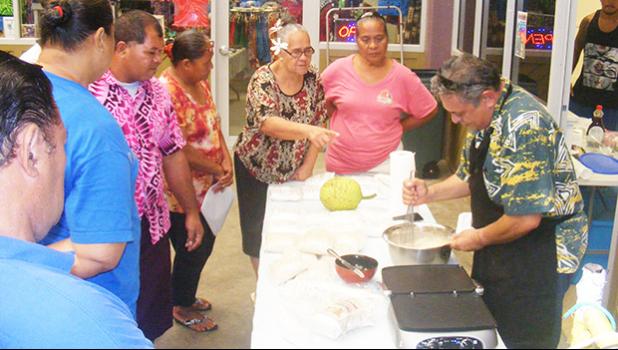 Rep. Su’a Alexander Eli Jennings and customers who showed up at his display table last week at the Fagatogo Market Place to check on gluten free breadfruit flour and two dried breadfruit that can be used to make hash brown.  [photo: FS]