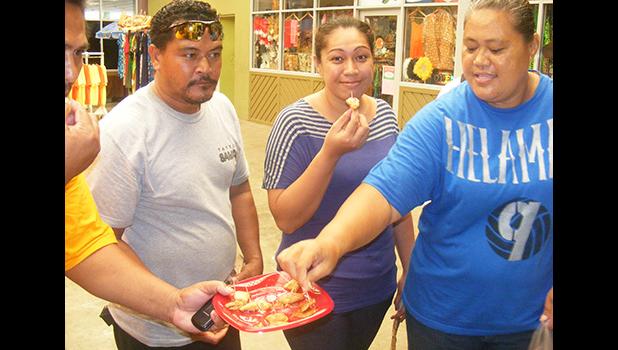 Some of the local residents as they taste samples of the gluten free breadfruit pancakes during a demonstration last Friday at the Fagatogo Market Place by Rep. Su’a Alexander Eli Jennings.  [photo: FS]
