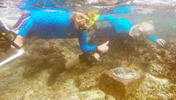 Dr. Charles Birkeland and Dr. Alison Green at the Aua Transect underwater marker. The Aua Village Transect project — the oldest survey of a coral reef in the world — celebrated its 100th anniversary last week. [photo: courtesy]