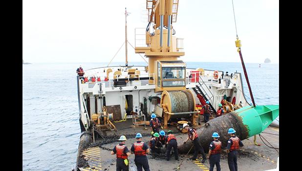 Juniper's crew servicing the green bouy at the entrance to Pago Pago harbor.