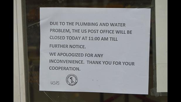 Photo of sign on door at USPS saying it would be closed TFN after plumbing problems discovered