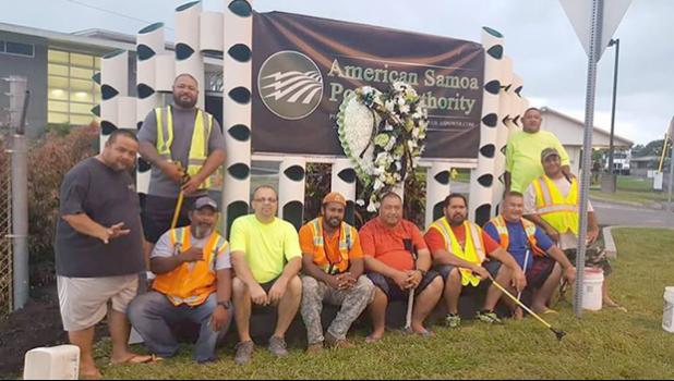 ASPA staff posing in front of wreath for Executive Director Utu at ASPA entrance 