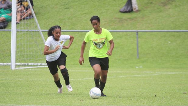 A Pago Youth defender, right, dribbles the ball out of danger against Utulei Youth