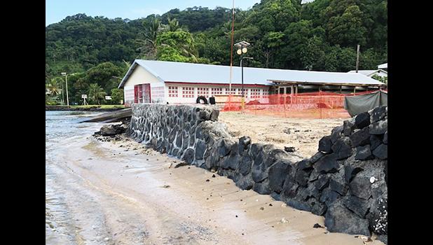 Rock wall going up on Utulei Beach behind DDW