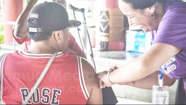 COVID-19 Vaccinations at the Samoa Tourism Authority center. Man getting COVID-19 vaccine