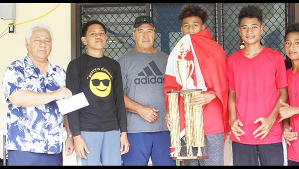 Members of the Vaiala Tongan Boys 13-15 team receive their championship trophy