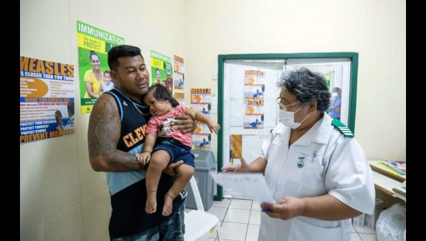 Dad with child getting vaccine