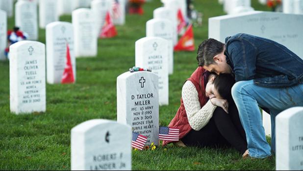 Victoria Ferguson is comforted by her husband, Phillip Ferguson, at the grave of her brother, David Taylor Miller, at Arlington National Cemetery on Nov. 11, 2015. Miller, who was killed in Afghanistan, would have marked his 25th birthday that Veterans Day. (Matt McClain/ The Washington Post) Victoria Ferguson is comforted by her husband, Phillip Ferguson, at the grave of her brother, David Taylor Miller, at Arlington National Cemetery on Nov. 11, 2015. Miller, who was killed in Afghanistan, would have marked his 25th birthday that Veterans Day. (Matt McClain/ The Washington Post)