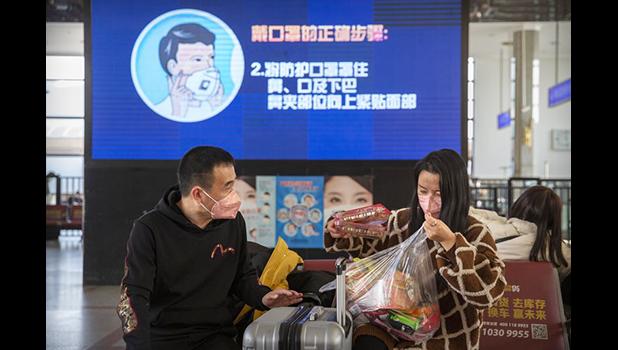 Travelers wearing face masks as