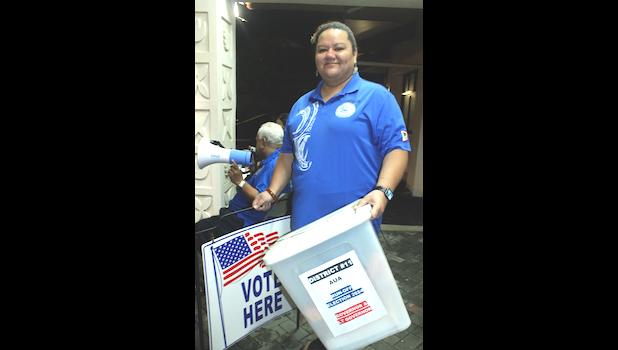 Woman carrying voting boxes