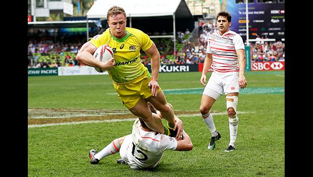 At the HSBC World Rugby Sevens Series XVIII in Hong Kong on April 8, 2017 Australia's Henry Hutchinson goes airborne against England to score Australia's first try.  Argentina beat England 12-10 to win Pool A.  Australia will play Argentina in the Cup quarter final.  England will play against USA.