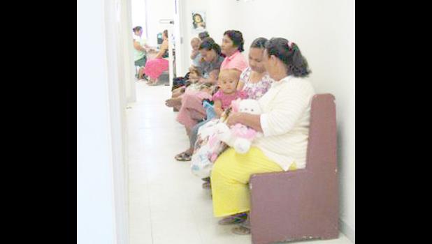 Mothers and babies wait at clinic