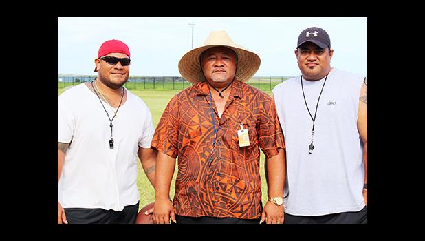 The Head Coach of the Nu’uuli Wildcats Football Program, NVTHS Principal Tupa’i Rod Atafua (center) posing for a coach’s photo with his assistant coaches Bill Ena (right) and Sene Ilileli (left) – not pictured are Christian, Viliamu, Pualau and Robert. [photo: TG]